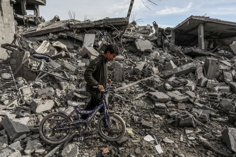 A Palestinian inspects damaged buildings after Israeli airstrikes on the city of Rafah in the southern Gaza Strip. Israeli special forces entered the buildings to free two Israelis who Hamas was holding. Abed Rahim Khatib/dpa