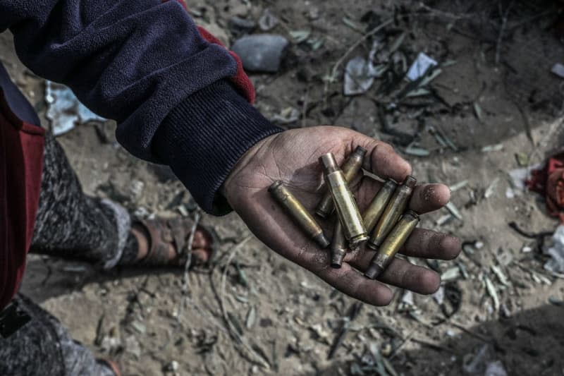 A Palestinian holds bullets after Israeli special forces entered residential buildings where two Israeli hostages were reportedly held in Rafah, southern Gaza Strip. The two hostages were rescued as part of an operation that began with heavy IDF airstrikes. Abed Rahim Khatib/dpa